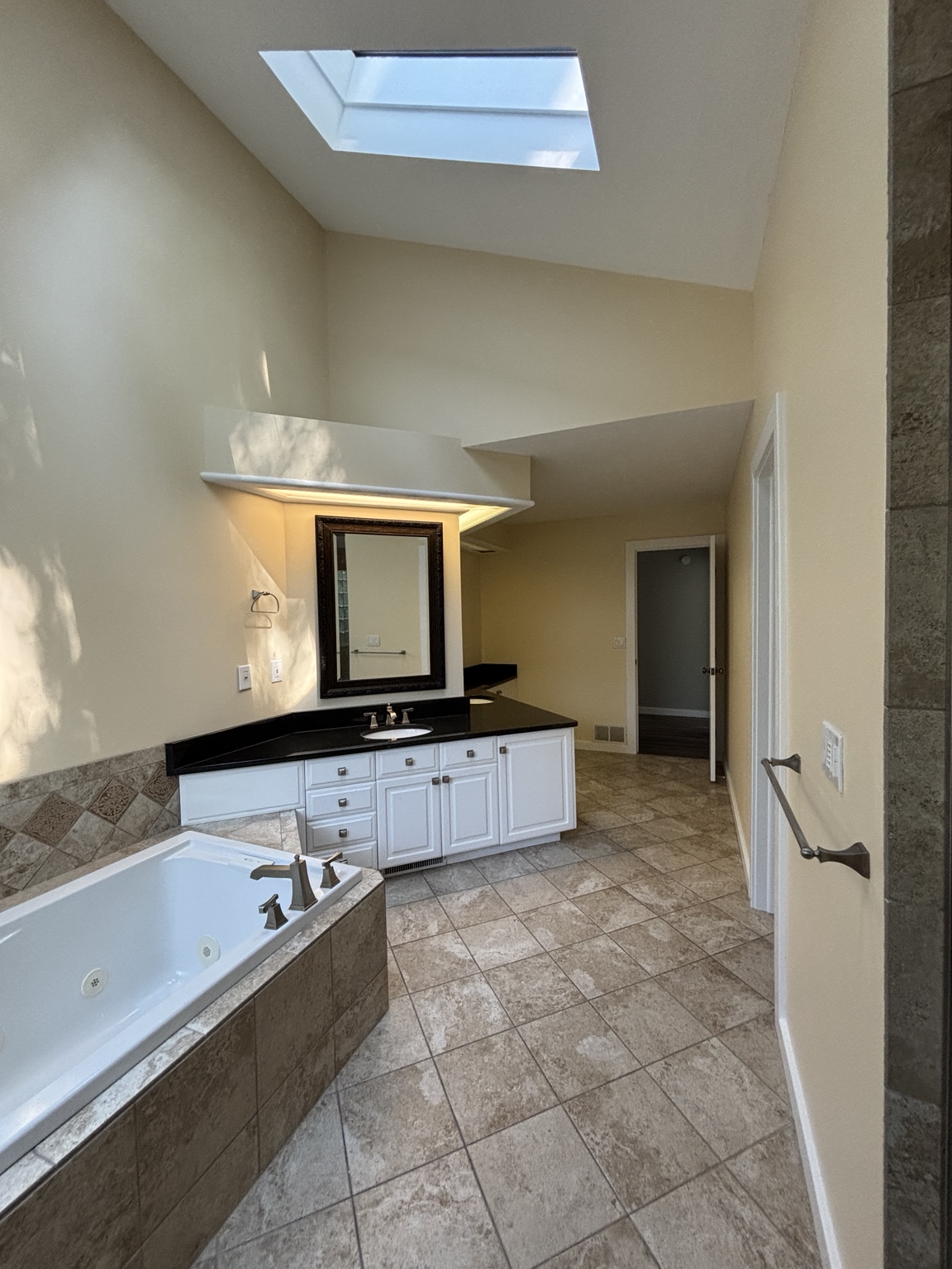 Completed bathroom interior with warm neutral walls and white trim