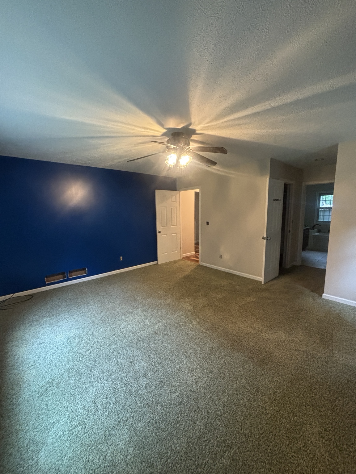 Finished bedroom with a deep blue accent wall